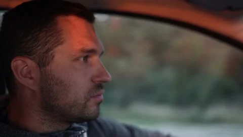Young man inside car. Happy positive caucasian man driving car fast. Blurred Stock Footage 166356744