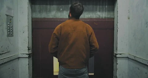 Young man inside elevator in industrial building, backside view Stock Footage 145358523
