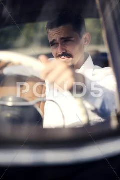 Young Man Inside Vintage Car