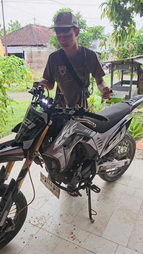 Young Man Inspecting Modified Supermoto Motorcycle Видео 332646924