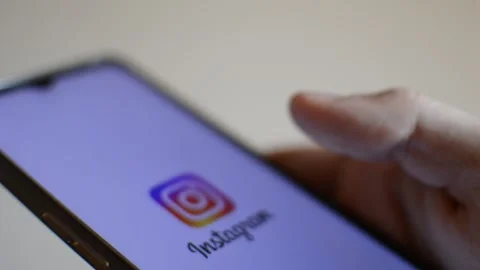 Young man with instagram social network app logo on his phone Stock Footage 192442559