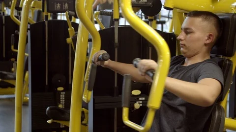 Young man with instructor working out in gym Stock Footage 125532339