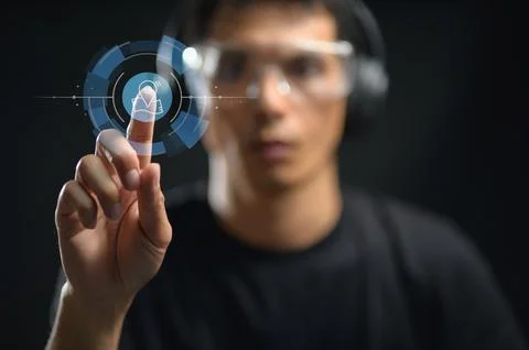 Young Man Interacting with Advanced Digital Touchscreen Interface in a Dark.. Stock Photos