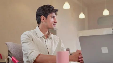 A young man interacting and working with a colleague in cafe or coworking space  Video stock 310291845