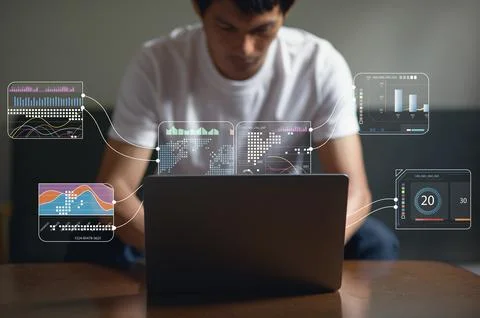 Young Man Interacting with Holographic Data Visualizations on Laptop Stock Photos
