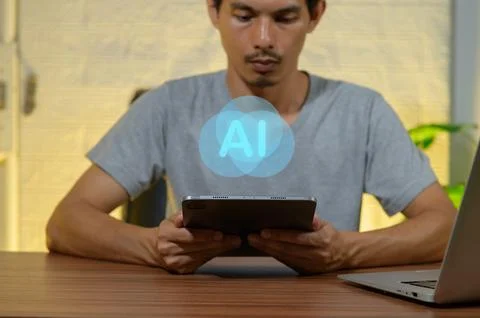 Young man interacting with tablet showcasing artificial intelligence concept Stockfoto's