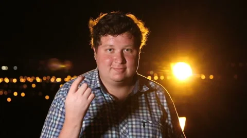 Young man inviting someone to come at night outdoor Stock Footage 101398327