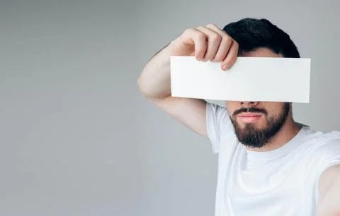 Young man isolated over background. Side view and selfie of bearded guy hide Stock Photos