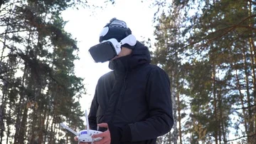 A young man in a jacket, with a control panel, in glasses of virtual reality aga Stock Footage 85994516