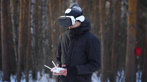 A young man in a jacket, with a control panel drones, in glasses of virtual real Stock-Footage 85994539