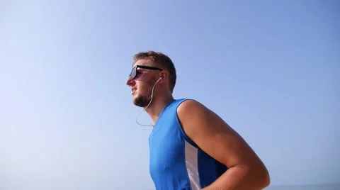 Young Man Jogging against Blue Sky 스톡 동영상 55218301