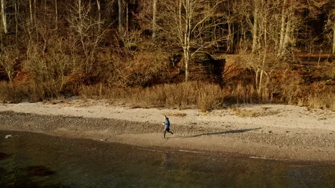 Young man jogging in the beach in Denmark Stock Footage 103214101