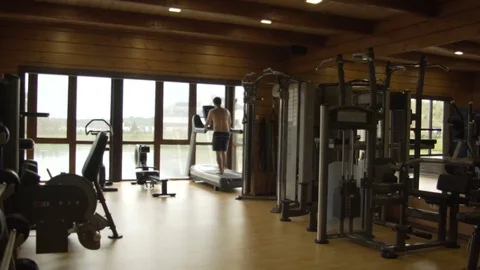 Young man jogging in the gym Stock Footage 78910772