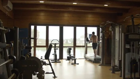 Young man jogging in the gym Stock Footage 78911014
