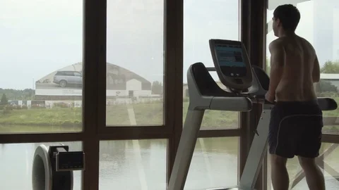 Young man jogging in the gym Stock Footage 78912270