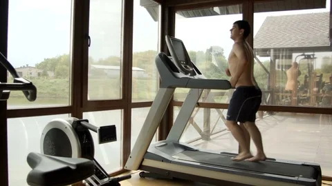Young man jogging in the gym Stock Footage 78913035