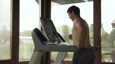 Young man jogging in the gym Stock Footage 78914052