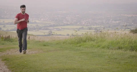 Young man jogging in meadow Stock Footage 59900003