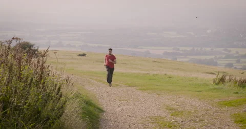 Young man jogging in meadow Stock-Footage 59911768