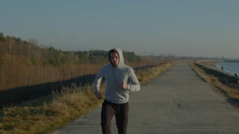 Young Man Is Jogging Outdoor Stock Footage 165819941