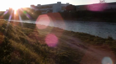 The young man jogging on the path along the river in the late hours of the day, 스톡 동영상 37848806