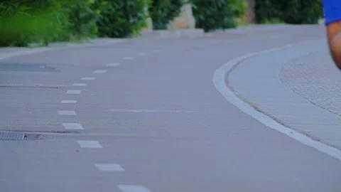 A young man jogging on a special track in the summer city park Stock Footage 110857610