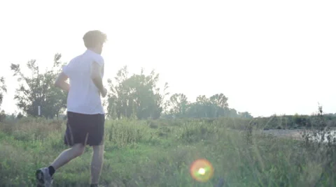 Young man jogging through beautiful setting Stock Footage 40770821