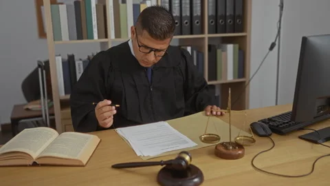 Young man in a judge's robe working in Stock Video Pond5