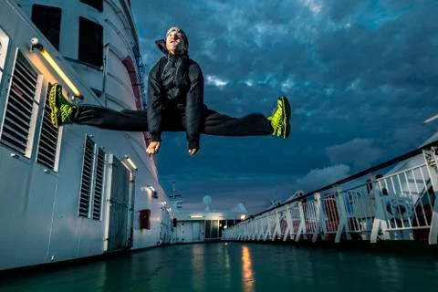 Young man jumping on the deck. Close up. Stock-Fotos