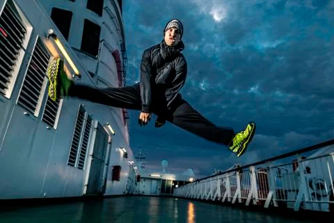 Young man jumping on the deck. Close up. Stock Photos