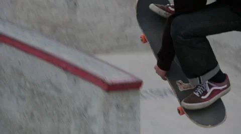 Young man jumping high and grabbing his skateboard in skate park Stock Footage 63505378