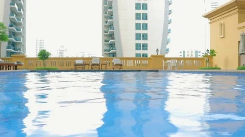 Young man jumping in the pool Stock Footage 75843398