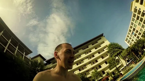 Young man jumping into the pool Stock Footage 104562877