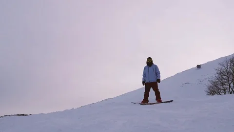 Young man jumping with snowboard in slow motion Stock Footage 85360183