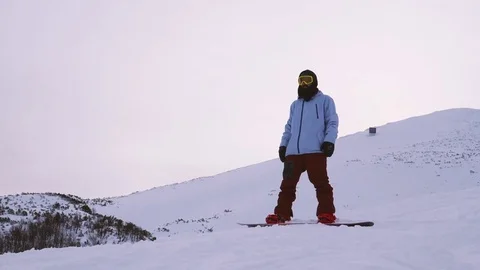 Young man jumping with snowboard in slow motion Stock Footage 85361153