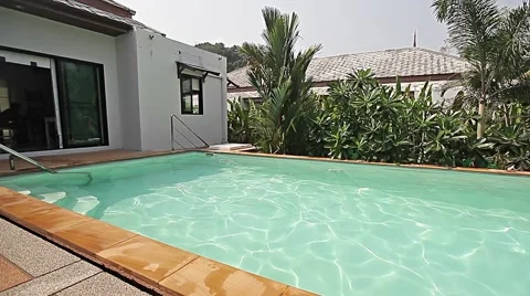 Young man is jumping to swimming pool in a villa 스톡 동영상 56865793