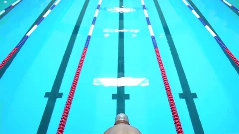 Young man jumping into a swimming pool Stock Footage 83392264