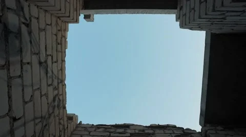Young man jumping through a hole in the building. bottom view Stock Footage 67315284