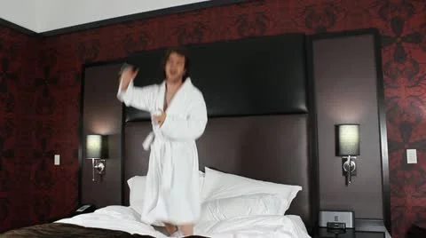 Young man jumps on bed V2 - HD Stock Footage 12235932