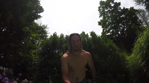 Young man jumps into pool onto inflatable float. Stock Footage 54303016