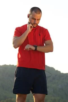 Young man keeping in shape and checking pulse Stock Photos