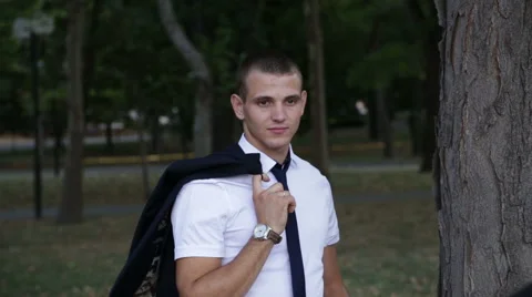 A young man, keeps the jacket on the shoulder Stock Footage 66303828