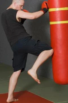 Young man kickboxing in gym Stock Photos