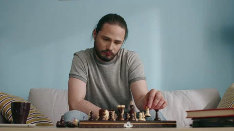 Young Man Kills Time by Playing Chess in Isolation Stock Footage 136289293
