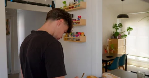 A young man is in the kitchen Stock Footage 336140290