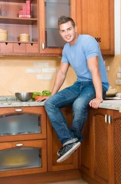 Young man in the kitchen Stock Photos