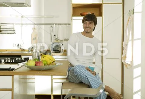 Young man in kitchen, portrait Stock Photos