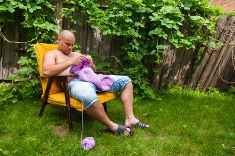 A young man knitting Stock Photos