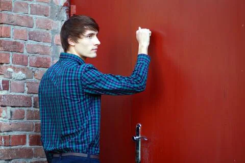 Young man knocking Stock-Fotos