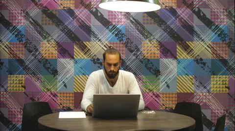 A young man with a laptop in a cafe Stock Footage 67094247
